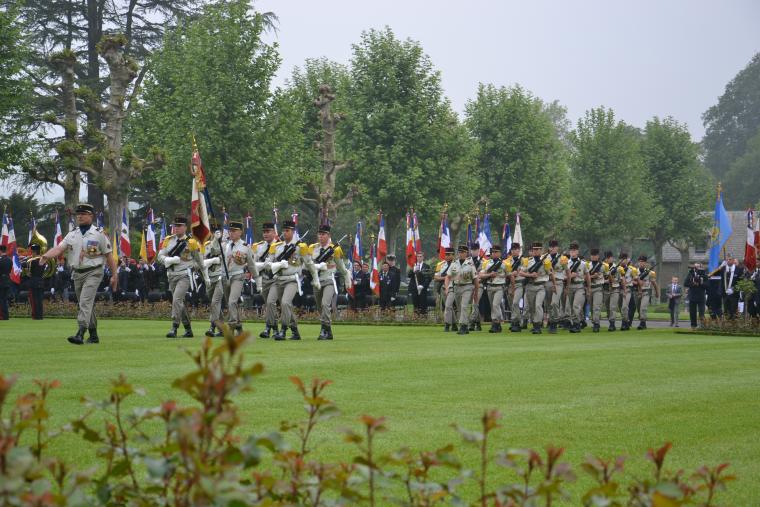Members of the French military march in during the ceremony. 