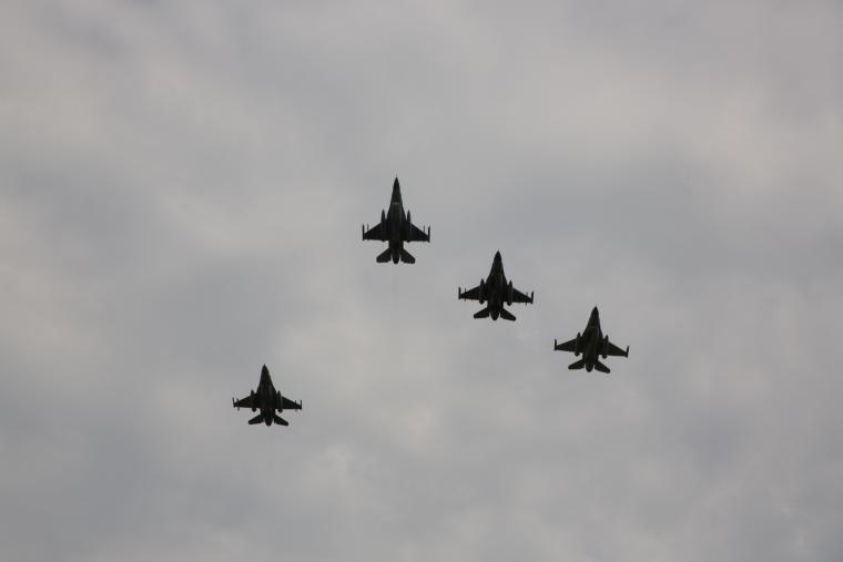 Four fighter jets in the sky are seen.