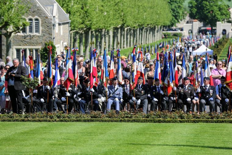 French flag bearers sit in the front row.