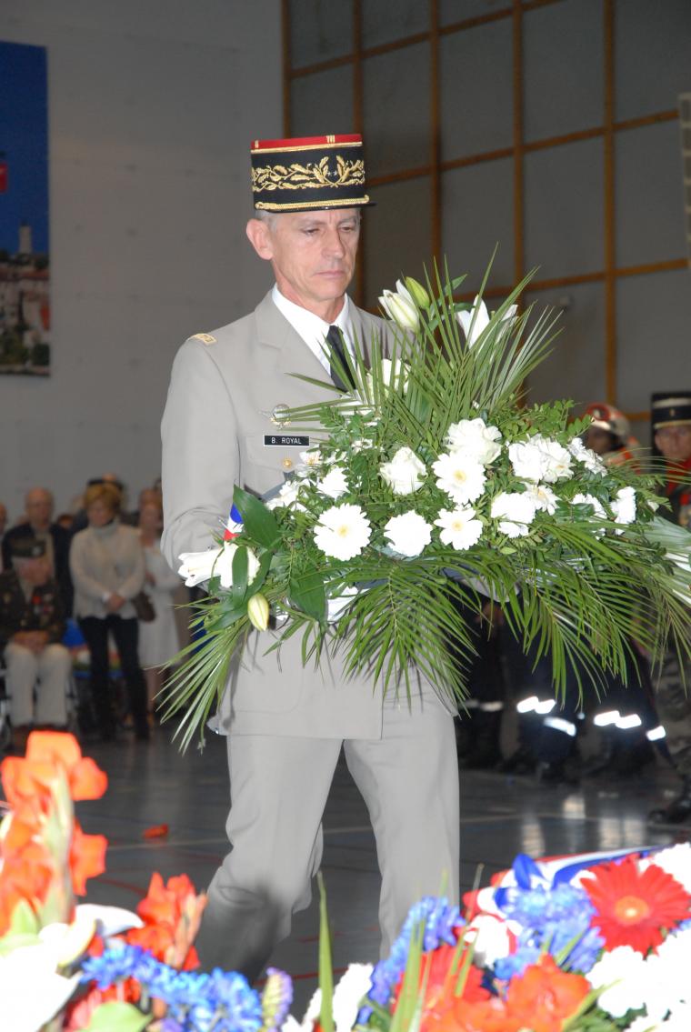 Gen. Royal prepares to lay a floral wreath during the ceremony. 
