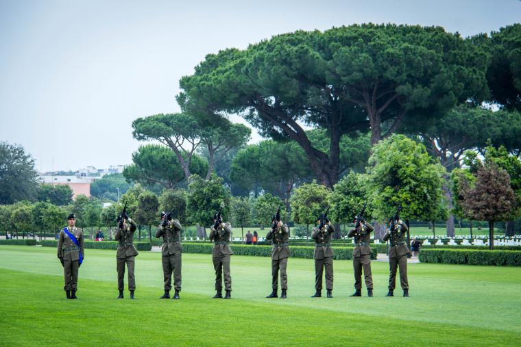 Members of the Italian military fire weapons into the air during the ceremony.