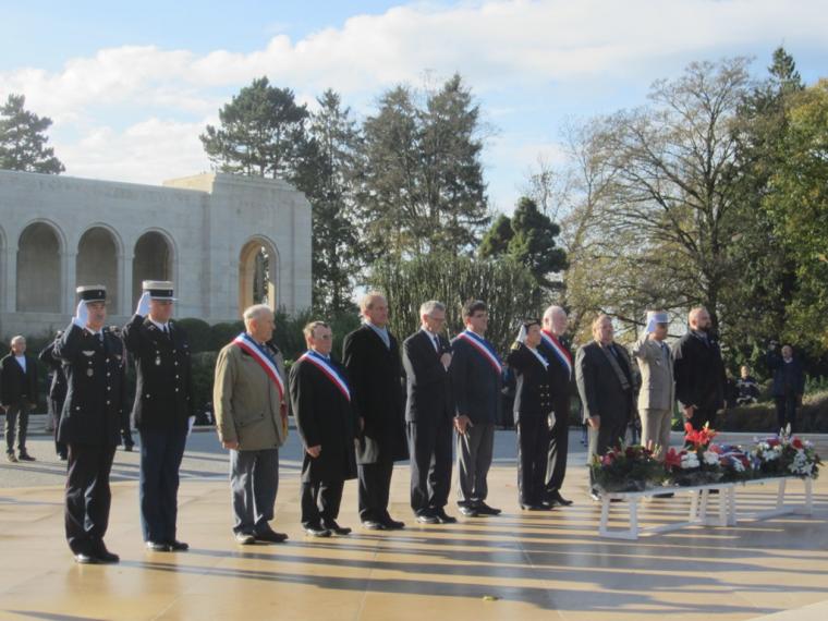 Members of the official party stand in front of chapel after wreath laying. 
