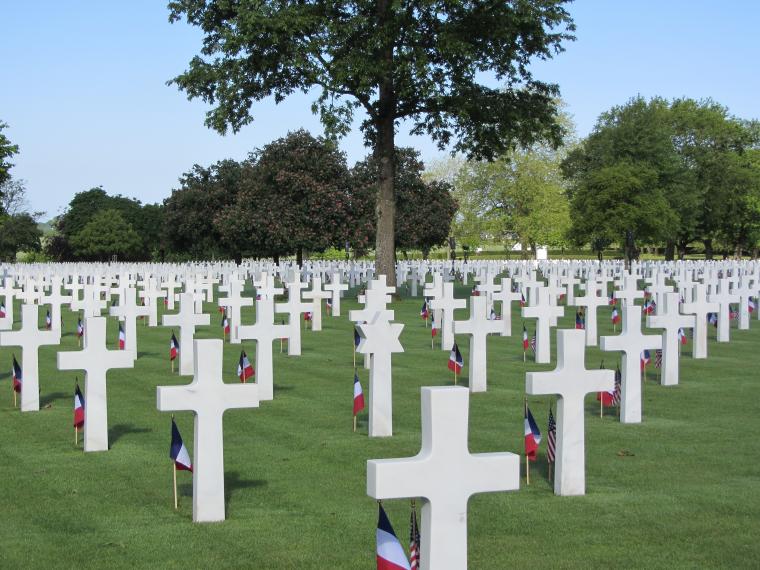 American and French flags in front of headstones. 