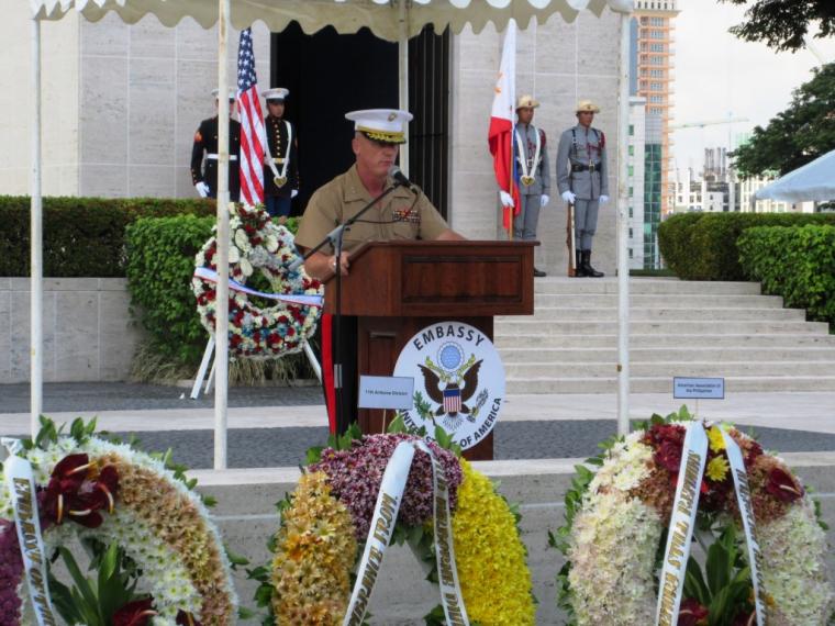 An American military official delivers remarks from the podium. 