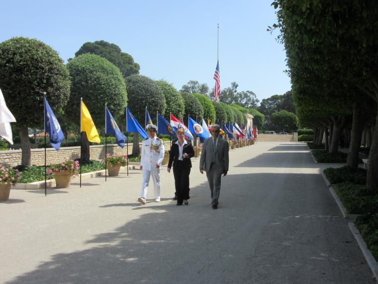 Members of the official party walk through the cemetery. 