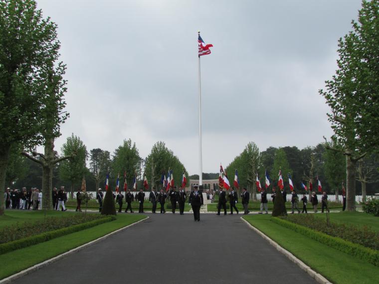 Ceremony participants walk down the main paved path through the cemetery. 