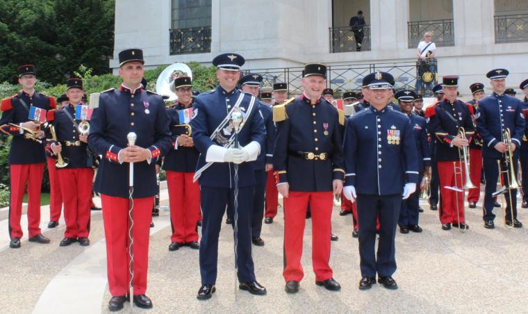 Men and women in uniform hold their instruments. 