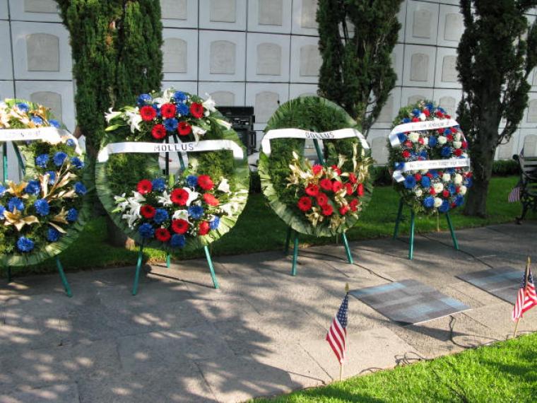 Large floral wreaths were laid during the ceremony. 