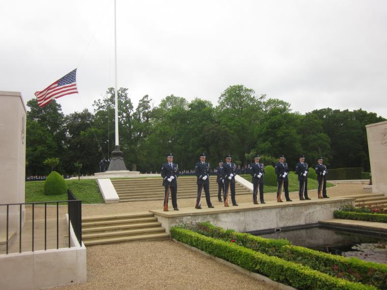 Members of the Air Force stand in front of the flag pole. 