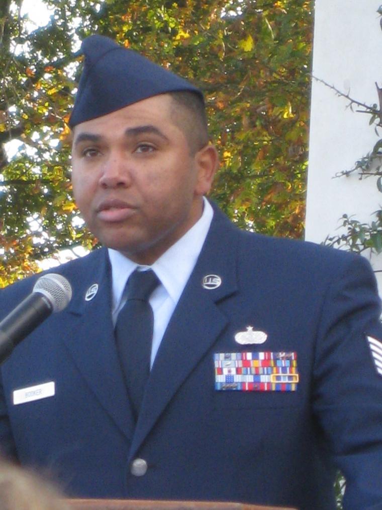 TSgt. Forrest L. Booker reads a poem from the podium. 
