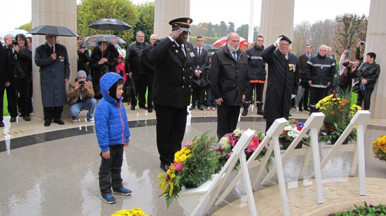 Members of the official party salute after the wreaths have been laid. 
