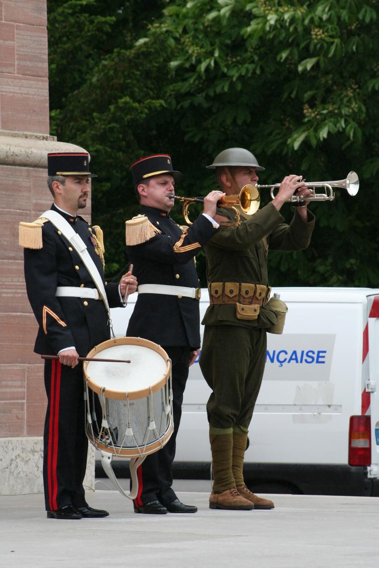 Members of the French military plays Taps during the ceremony. 