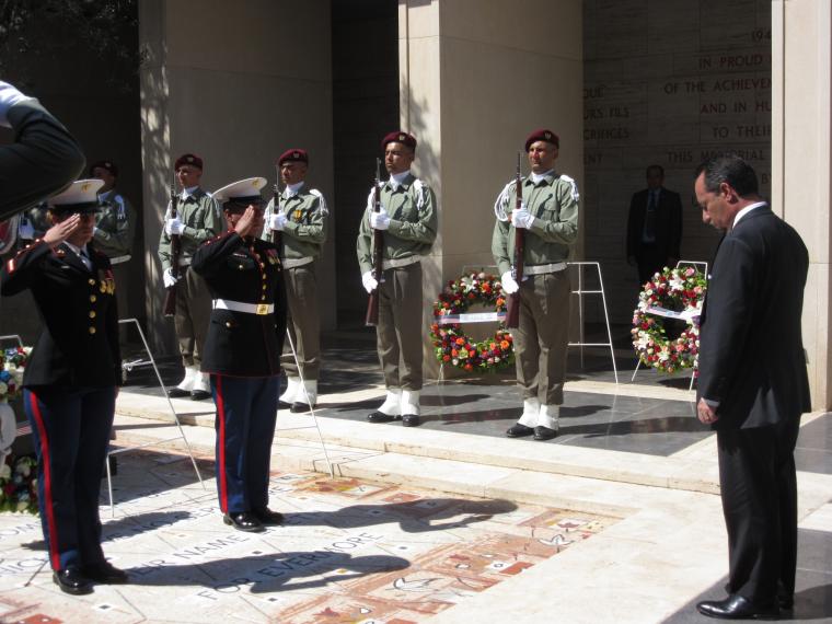 Two Marines salute the ambassador after he laid the wreath.