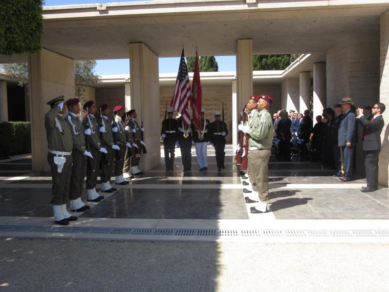 The Honor Guard departs while members of the Tunisian military stand in straight lines on both sides.