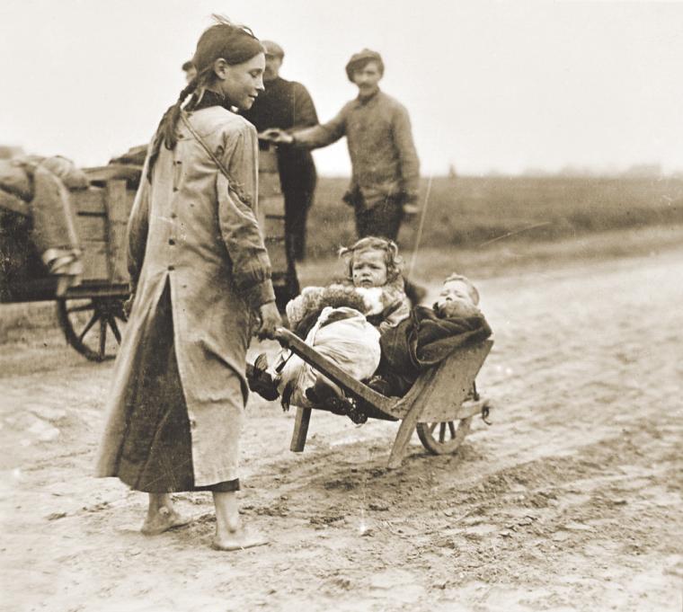 Belgian refugees walk towards Waregem, to return to areas liberated by American units.