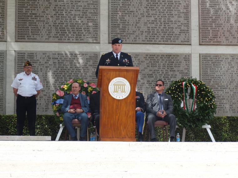 Lt. Gen. Hodges speaks from a podium in front of the Tablets of the Missing. 