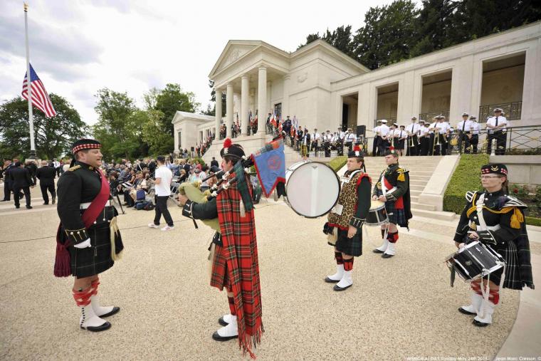 A bagpiper and drummers are ready to play during the ceremony. 