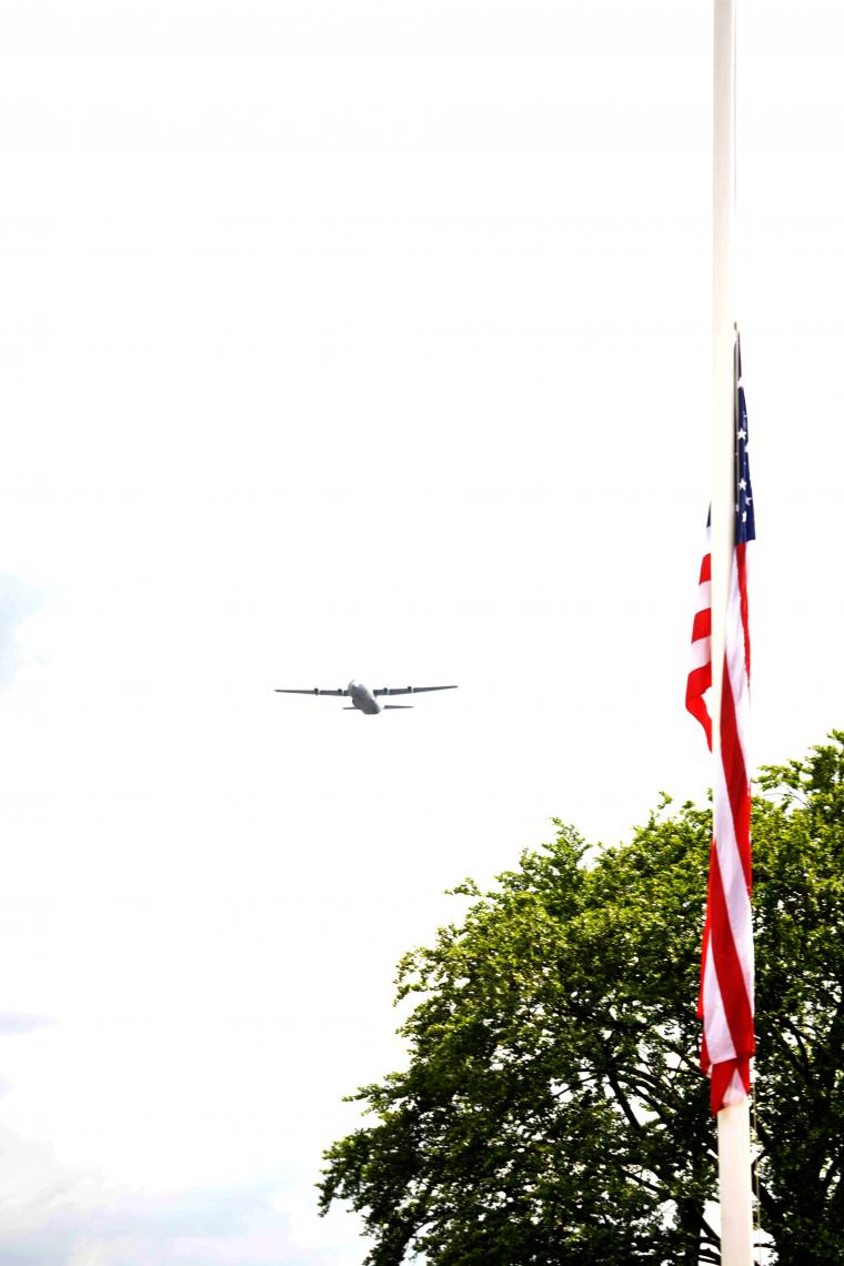 A plane flies over the cemetery during the ceremony.