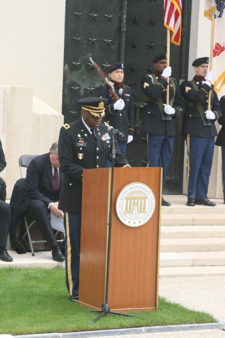 A man in uniform delivers remarks from the podium.