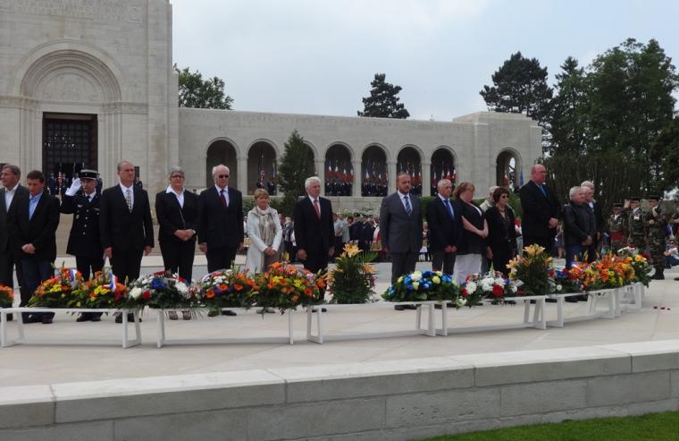 French officials stand and reflect after laying their wreaths.