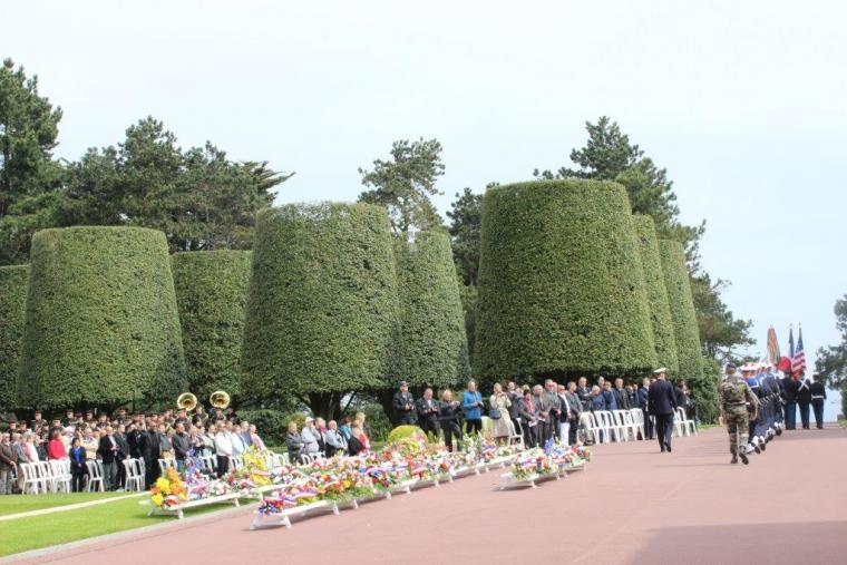 Floral wreaths rest on stands during the ceremony. 