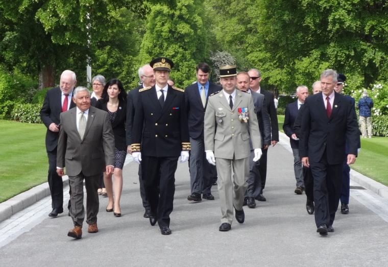 Members of the official party walk through the cemetery.