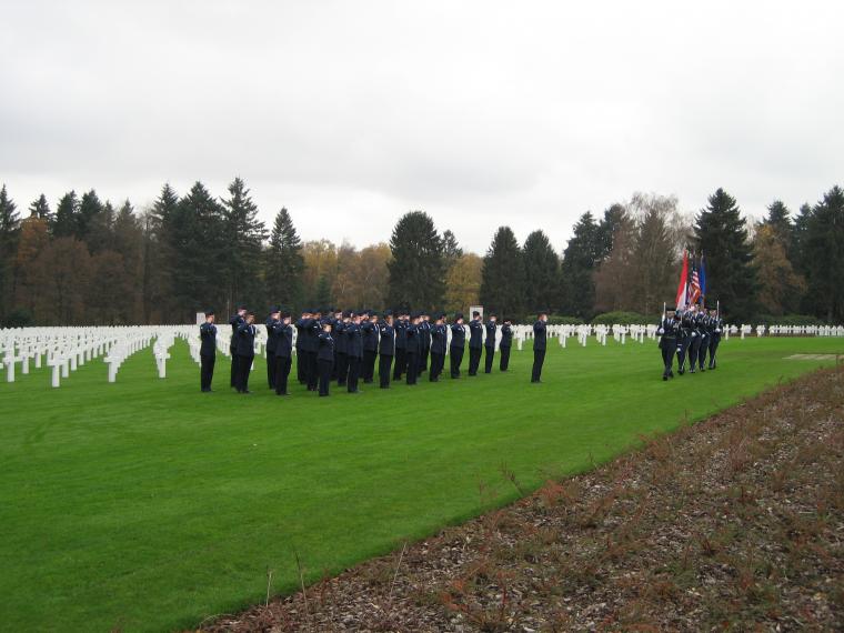 The Honor Guard posts the colors while members of the American military salute. 