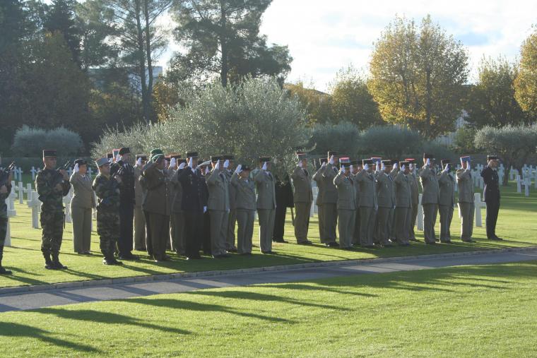 Members of the French military salute during the ceremony. 