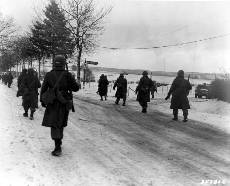 Members of the 101st Airborne move out of Bastogne. 