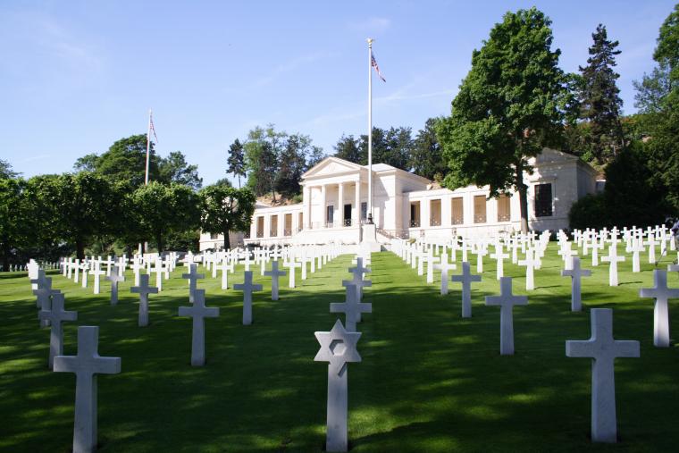 Rows of marble headstones are seen in front of the chapel at Suresnes American Cemetery.