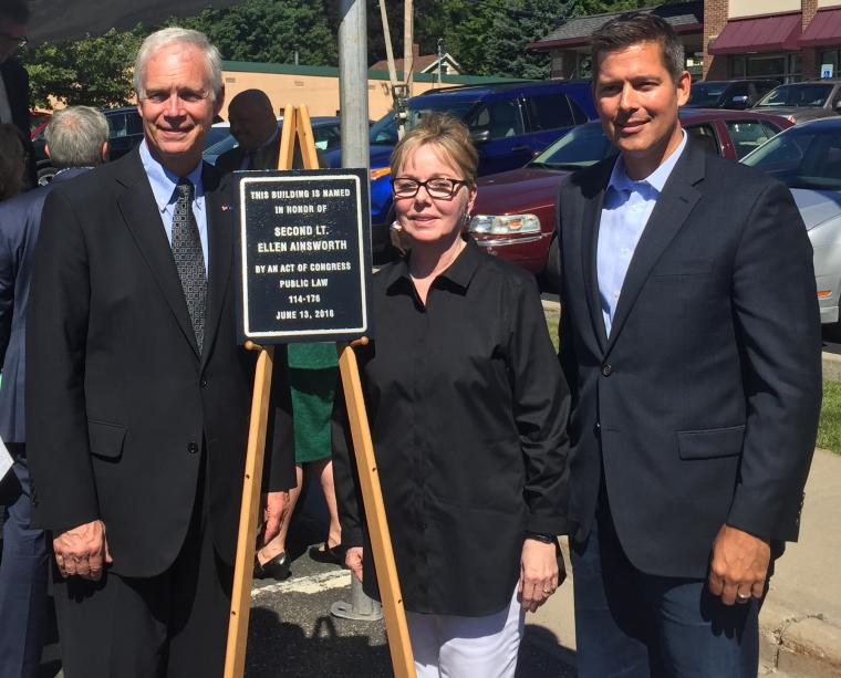 Senator Ron Johnson, Sally Berkholder, and Congressman Sean Duffy stand next to the plaque. 