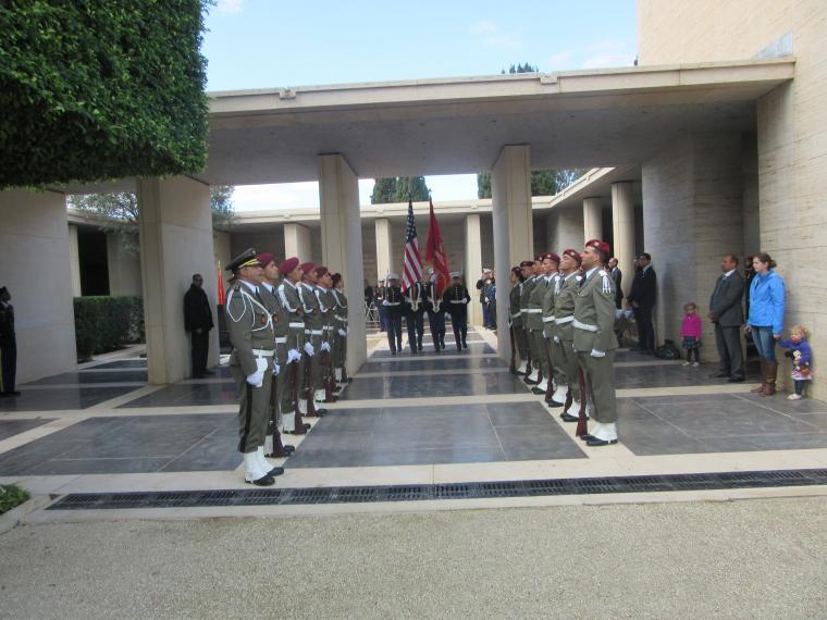 Members of the Tunisian military flank the Marine Color Guard as they depart the ceremony. 