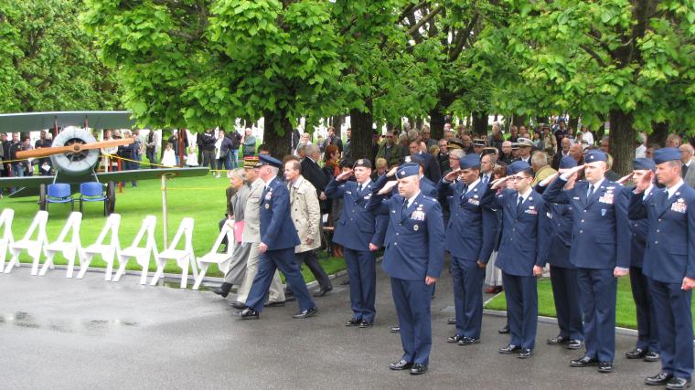 Members of U.S. military salute during the ceremony.