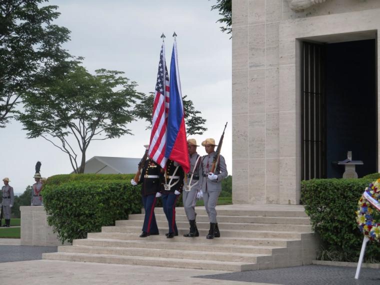 Members of the Color Guard march down the stairs outside the chapel. 