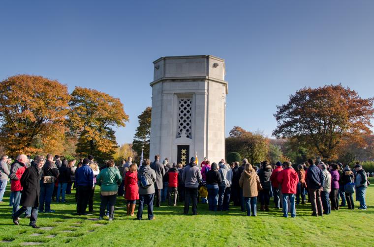 People stand in a group around the chapel. 