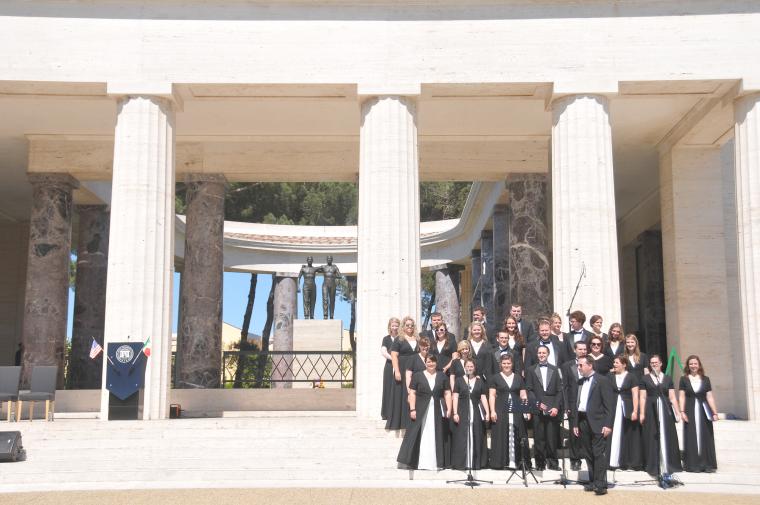 The choir performs on the steps of the memorial building. 