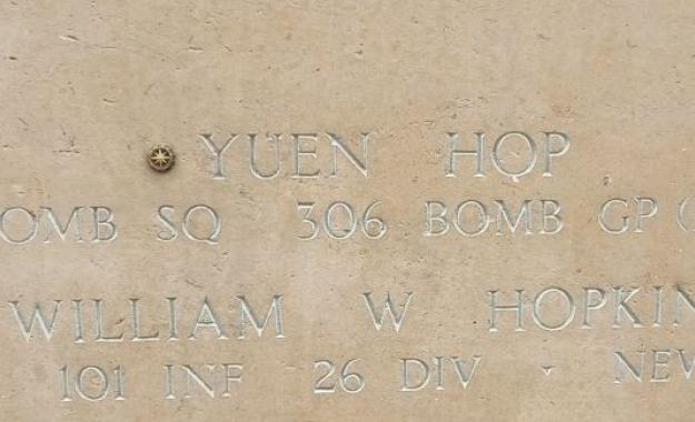 A bronze rosette is placed next to the name of Yuen Hop